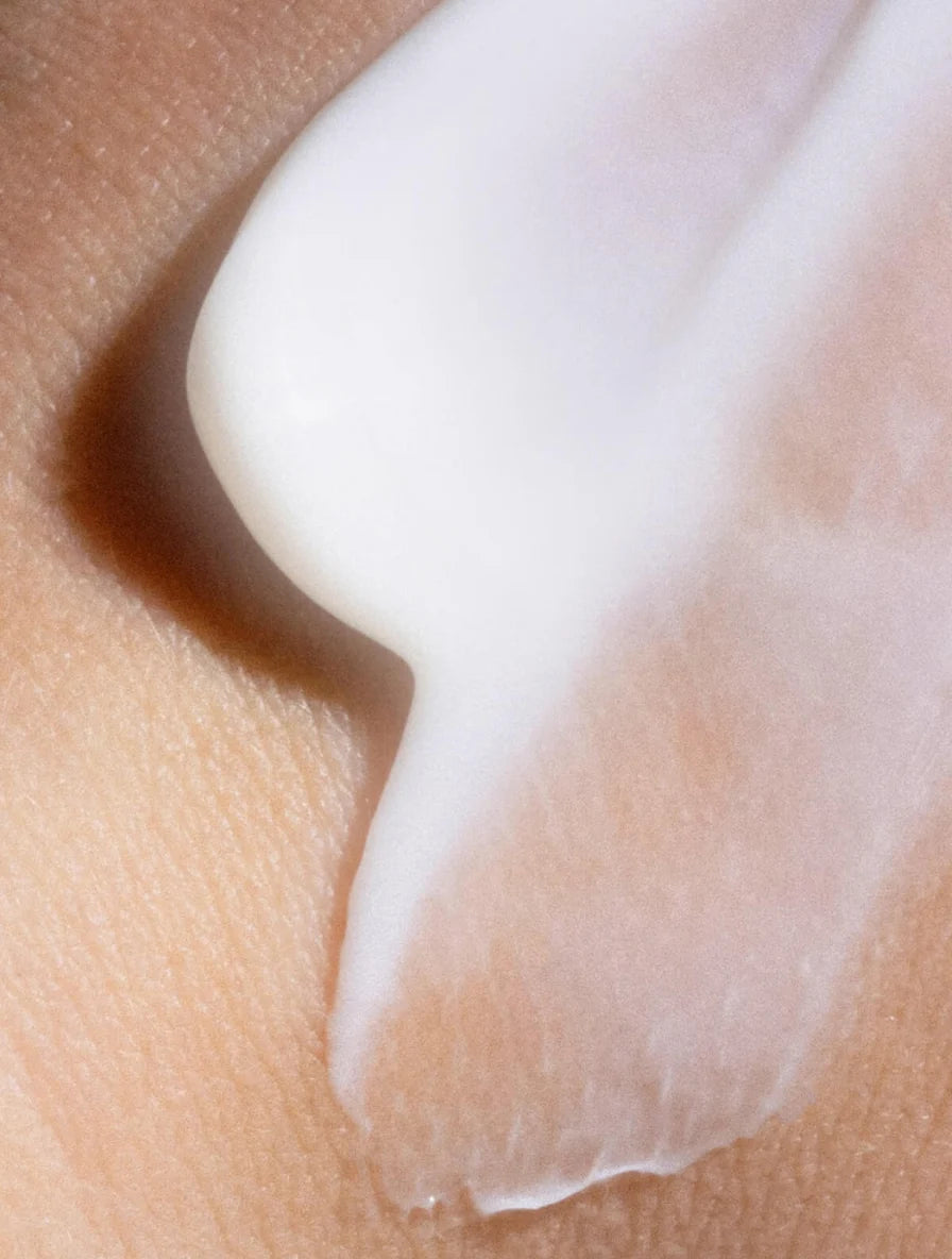 White cream texture on human skin.