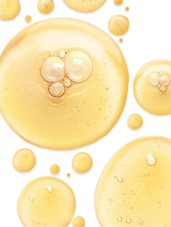 Yellow and brown drops of Gingko gel booster on white background.