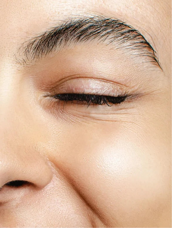 Happy woman close-up on closed eye.