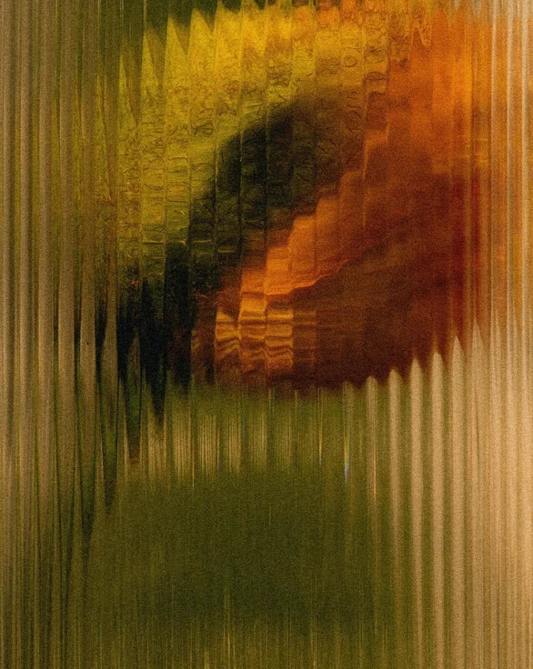 Flower behind tinted textured glass.