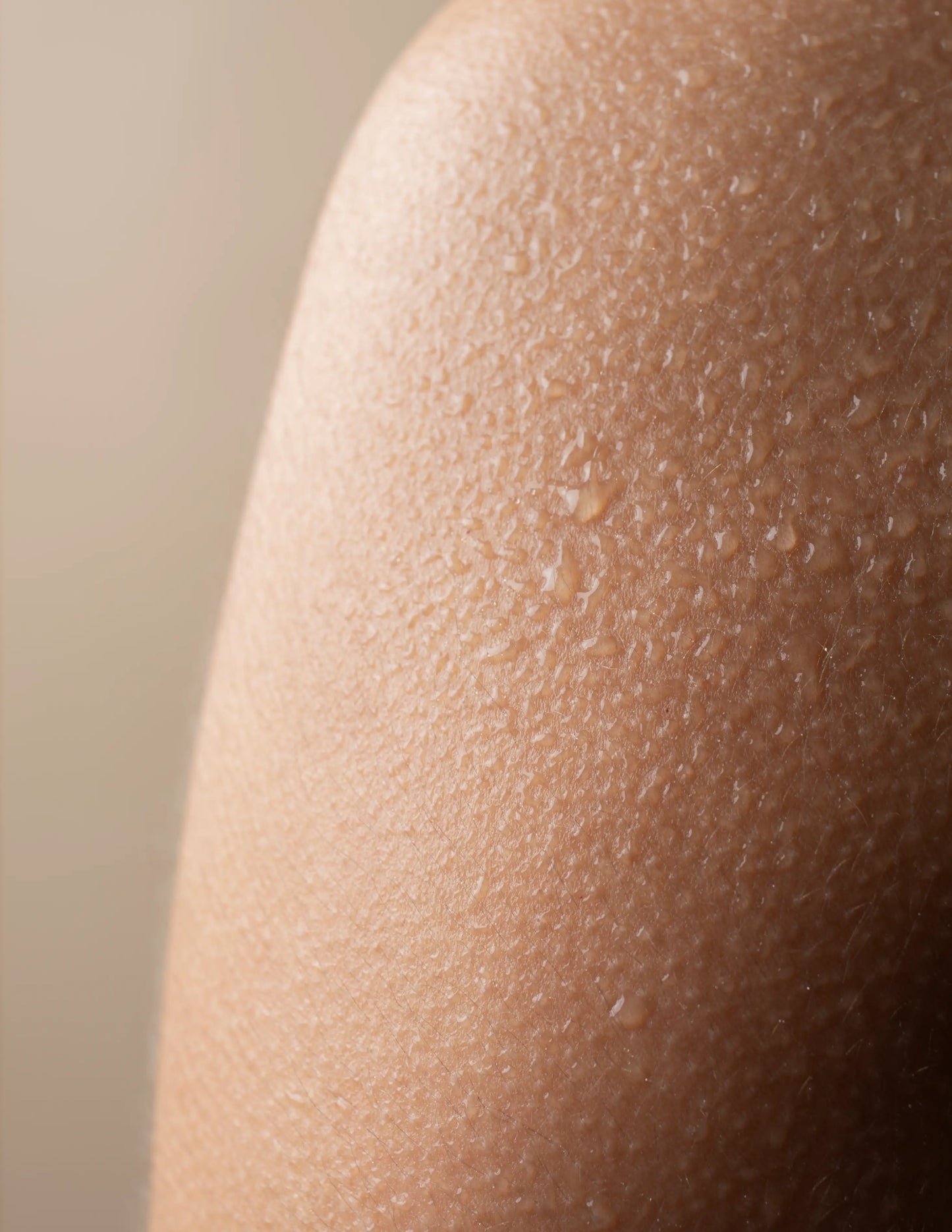 Close-up of human skin with water drops.