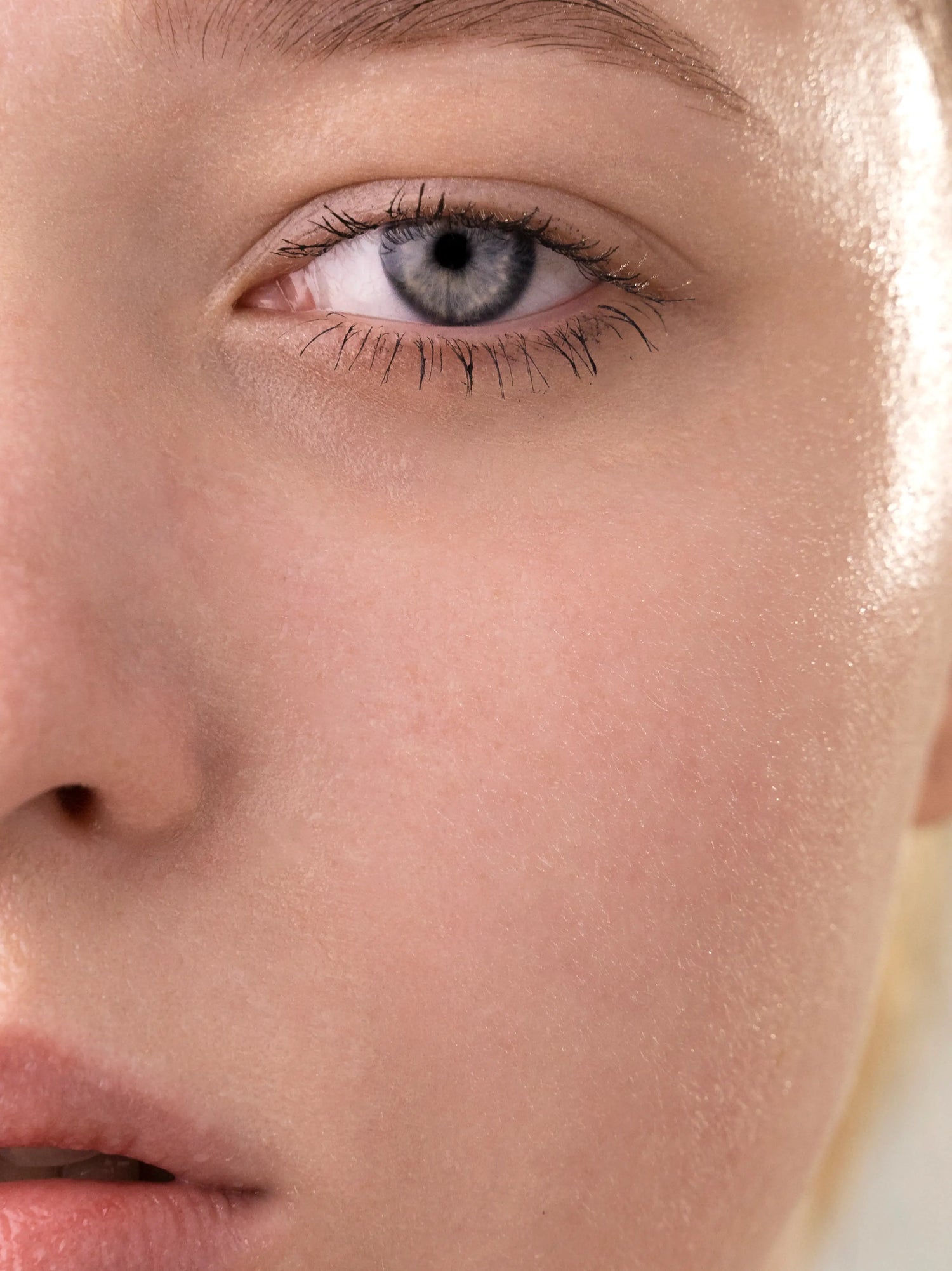 Close-up of a person's eye with a neutral background.