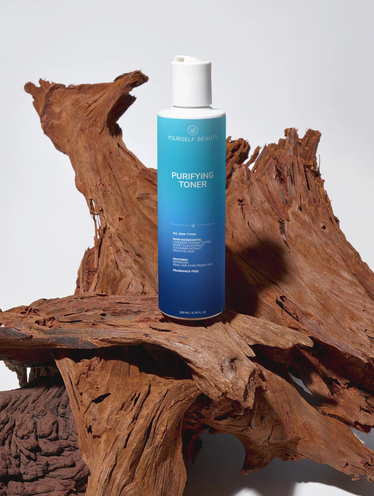 Yourself Beauty blue toner bottle labeled 'Purifying Toner' on a wooden surface.