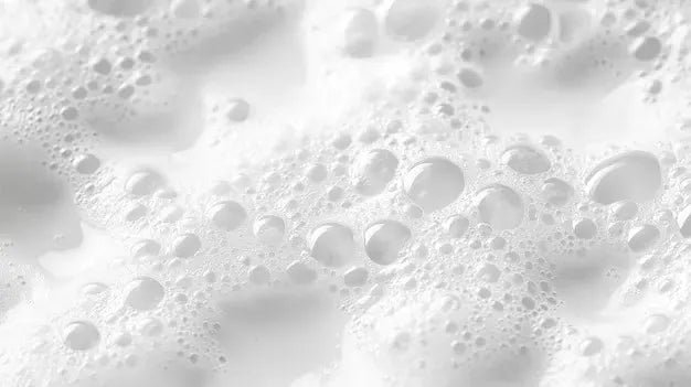 Close-up of white foam texture with bubbles.