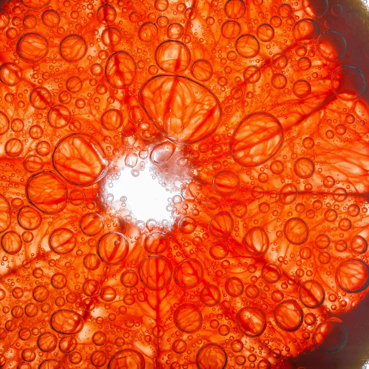 Close-up of red orange with bubbles.