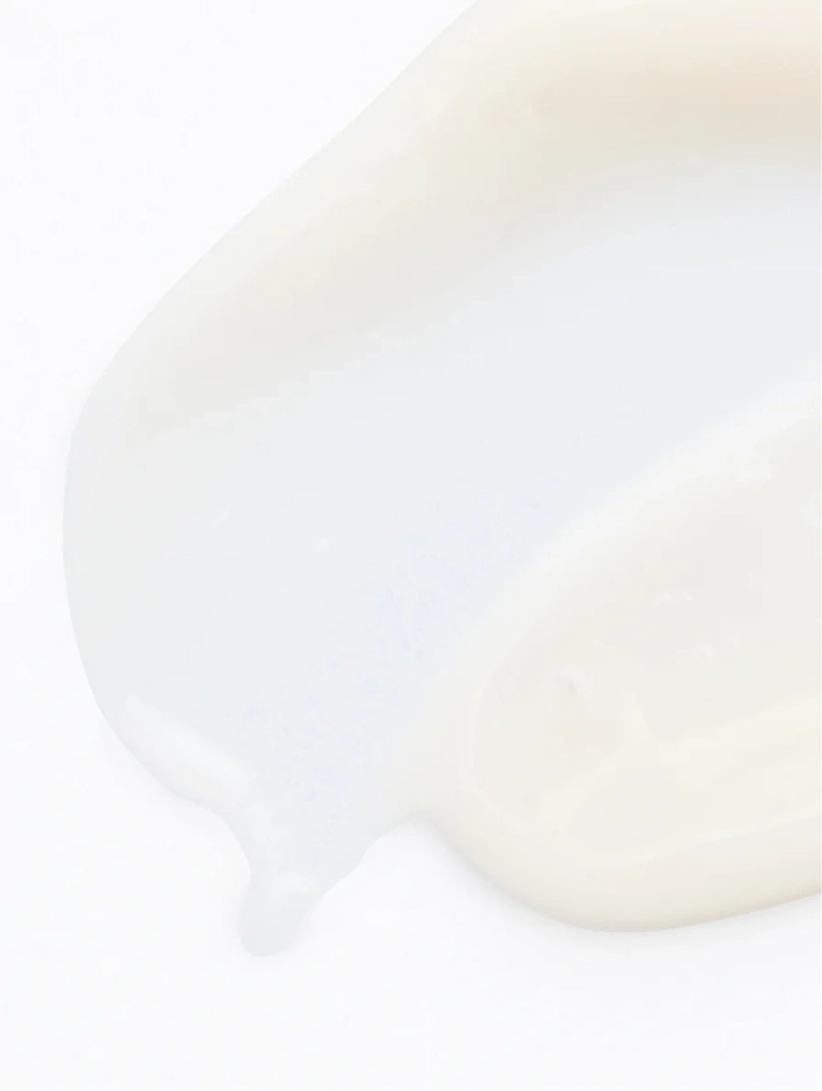 Close-up of white serum texture on a white background.